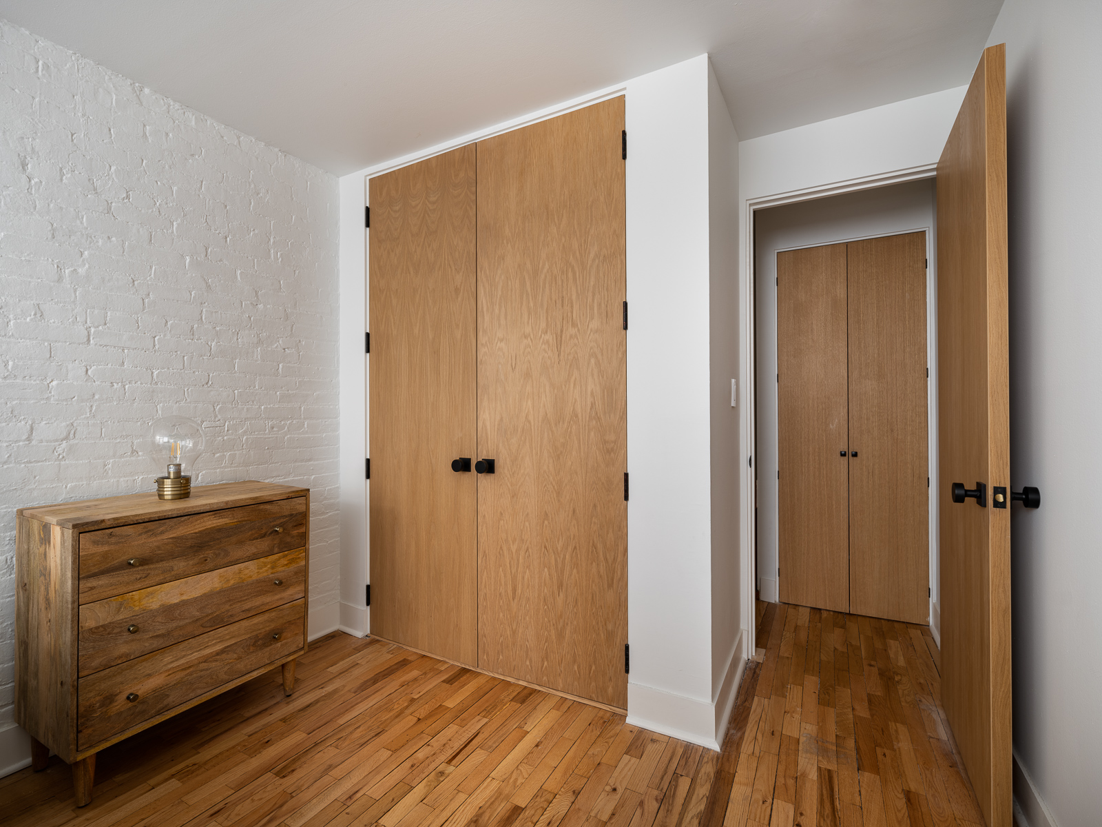 23 East 10th Street, Unit 404 Manhattan, NY 10003 - Photo 9 of 11 a view of room with closet and wooden floor