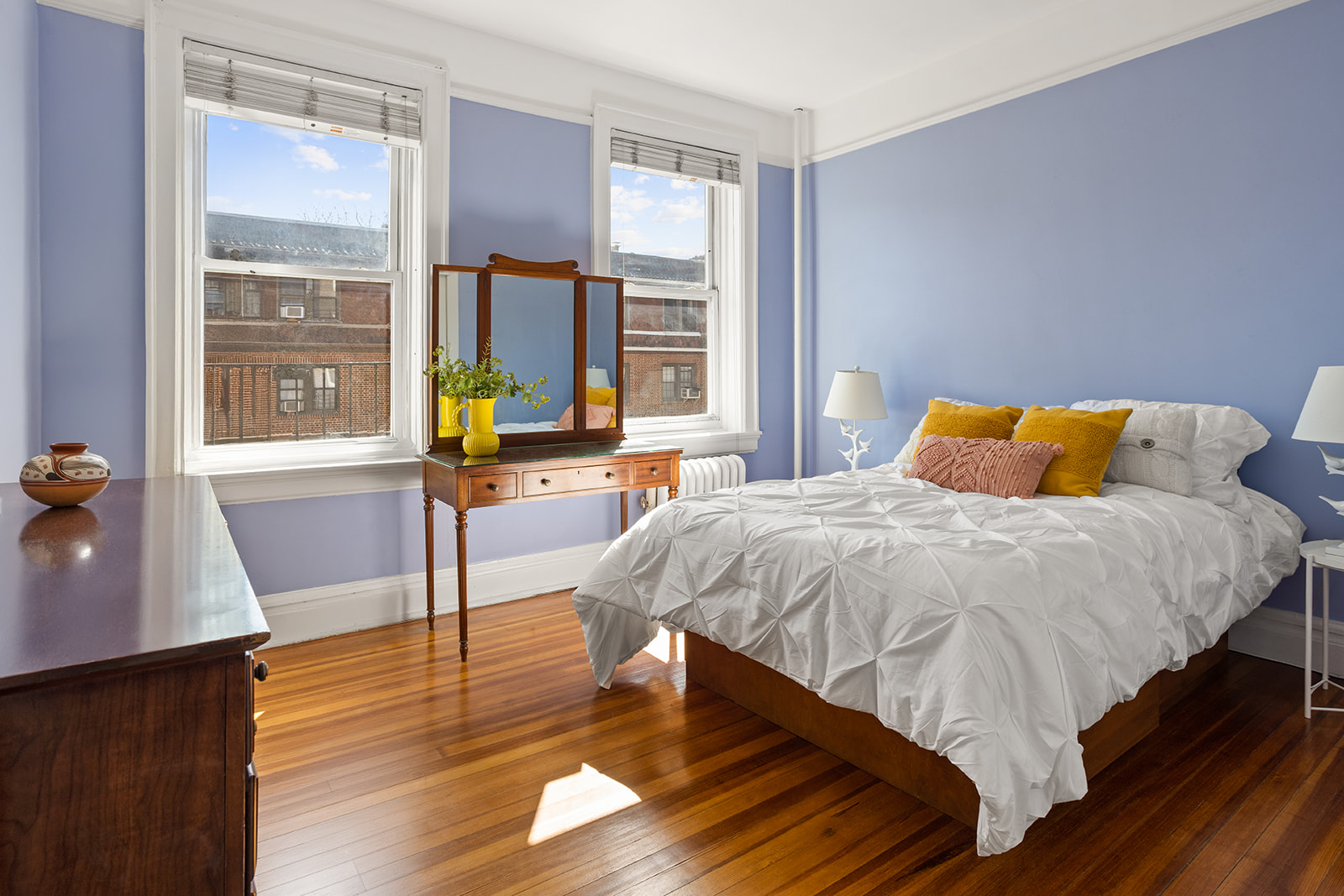 34-43 82nd Street, Unit 22 Queens, NY 11372 - Photo 5 of 11 a bed sitting in a bedroom next to a window