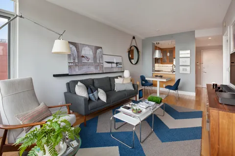 a living room with furniture and a table