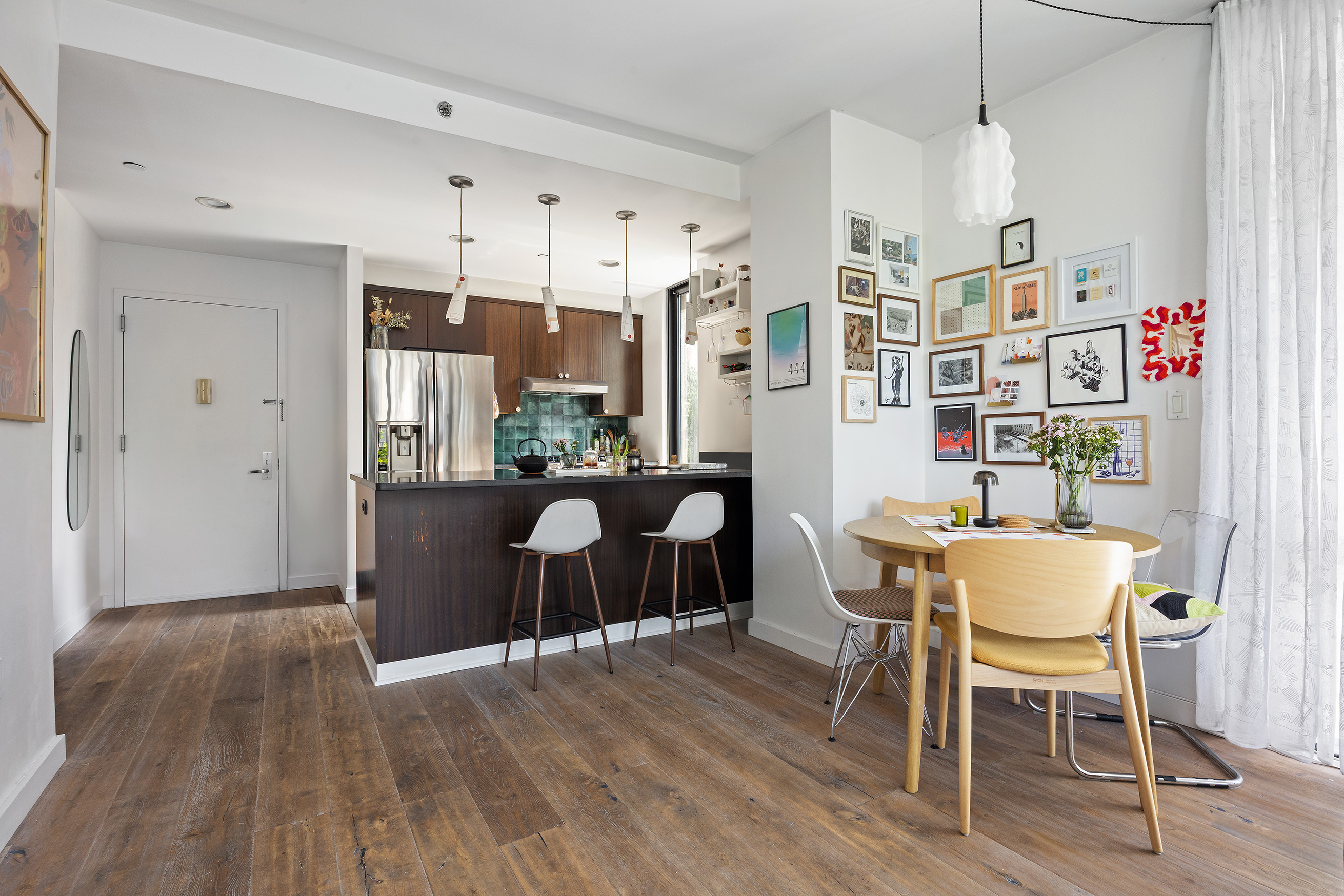215 Avenue B, Unit 4A Manhattan, NY 10009 - Photo 4 of 13 a dining room with furniture and wooden floor