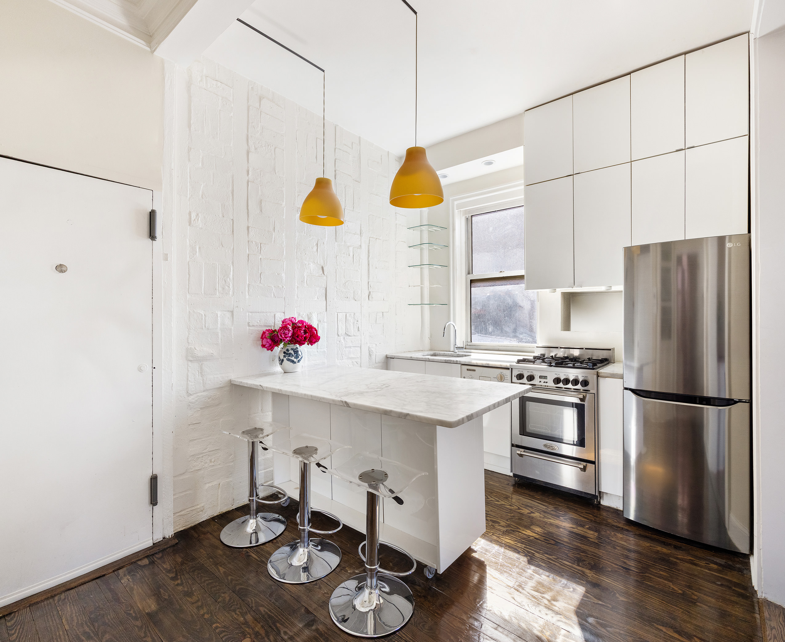 327 West 11th Street, Unit 5R Manhattan, NY 10014 - Photo 3 of 6 a kitchen with stainless steel appliances granite countertop a sink a stove and refrigerator