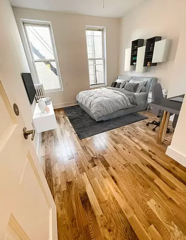 1128 Bushwick Avenue, Unit A Brooklyn, NY 11221 - Photo 10 of 14 a bedroom with two beds and a large window