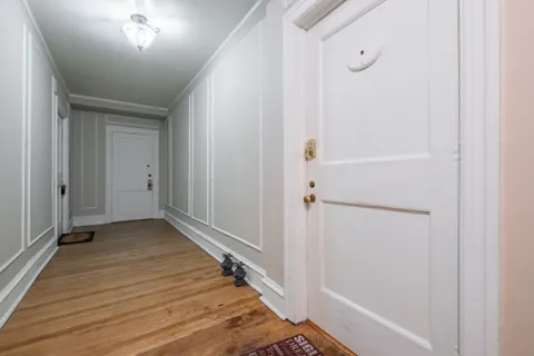 a view of a hallway with wooden floor