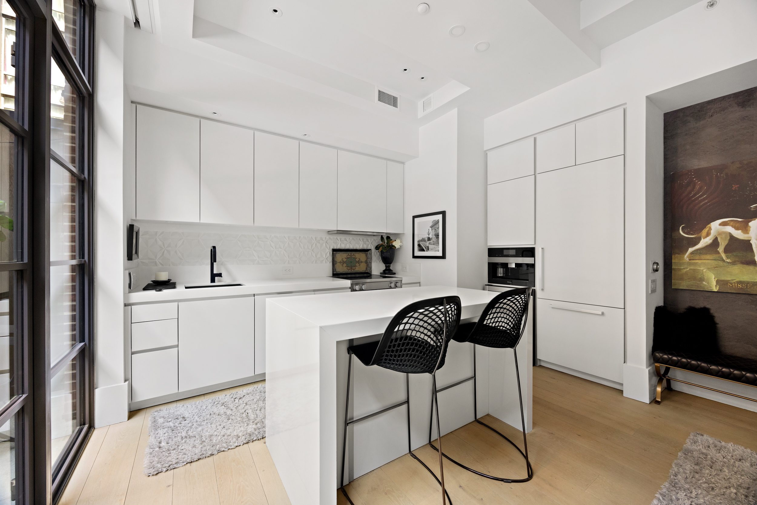 404 Park Avenue South, Unit 3E Manhattan, NY 10016 - Photo 8 of 21 a kitchen with a dining table cabinets and appliances