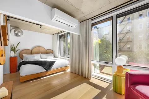 a bedroom with furniture and a window