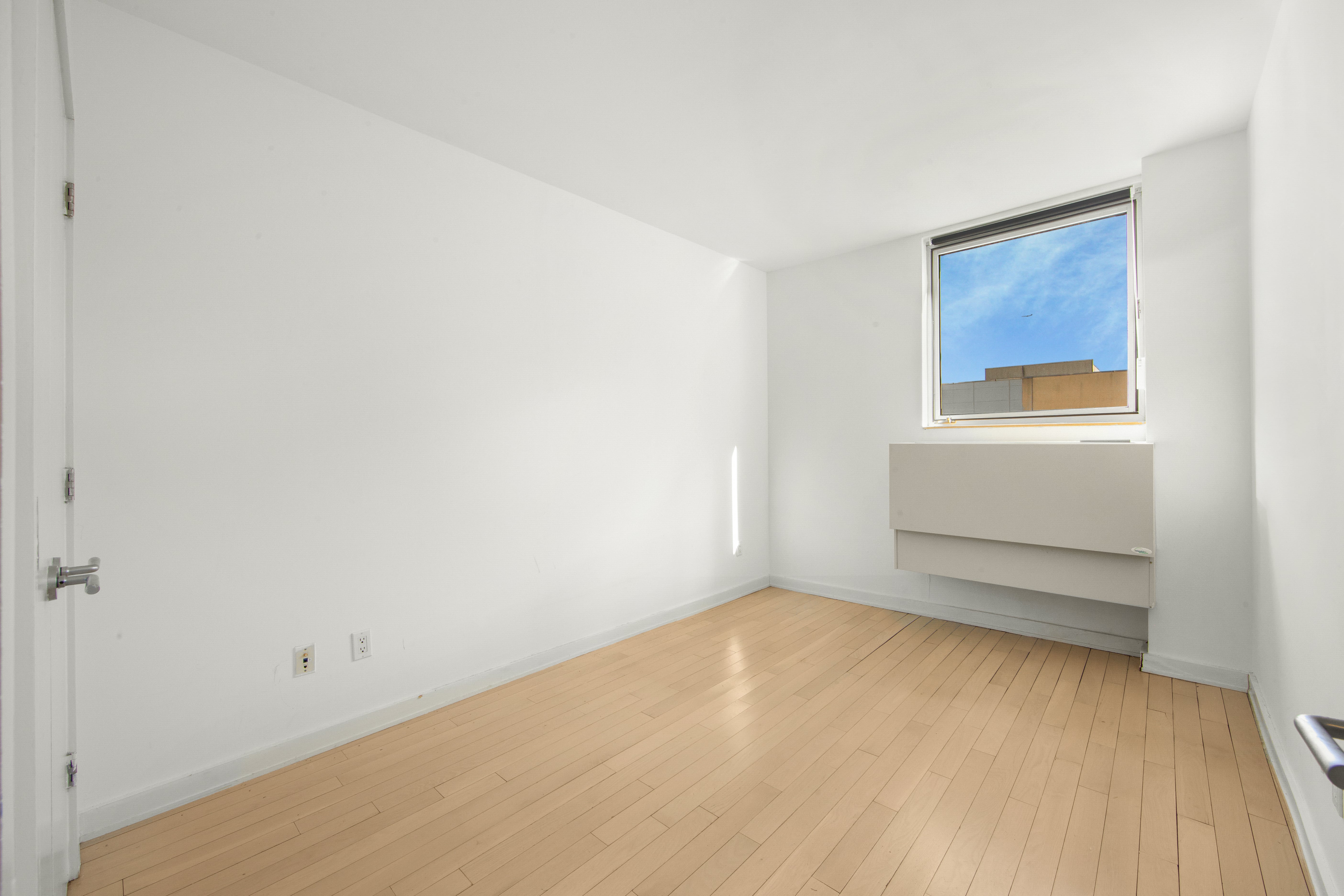 250 Bedford Avenue, Unit 129203 Brooklyn, NY 11249 - Photo 7 of 8 a view of an empty room with a window