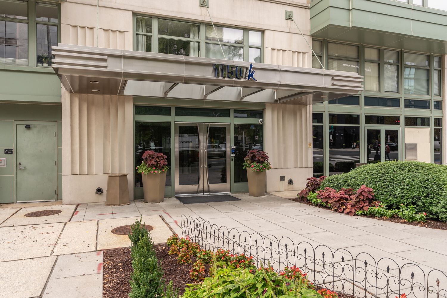 a front view of a building with a garden