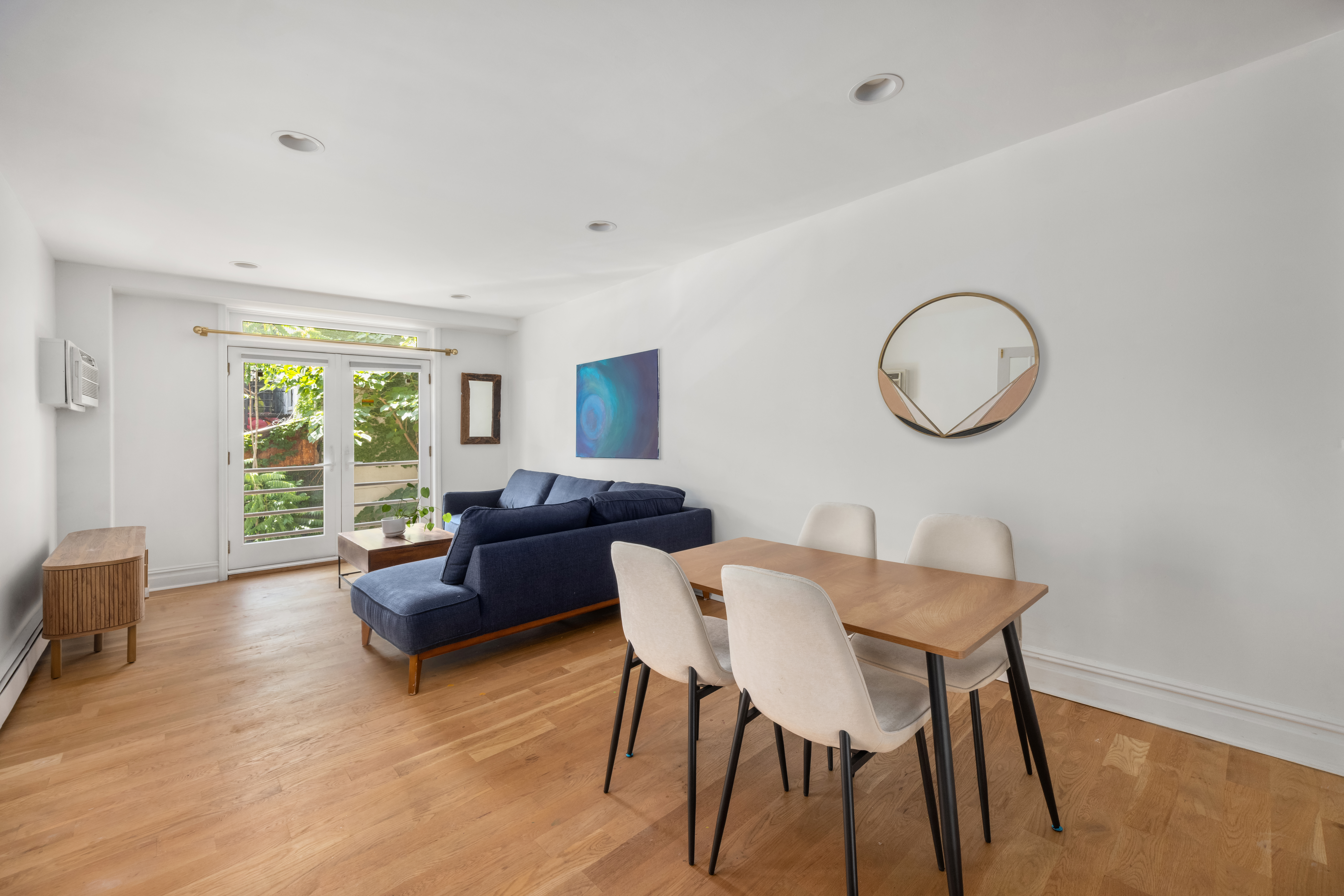 a living room with furniture a table and a large window
