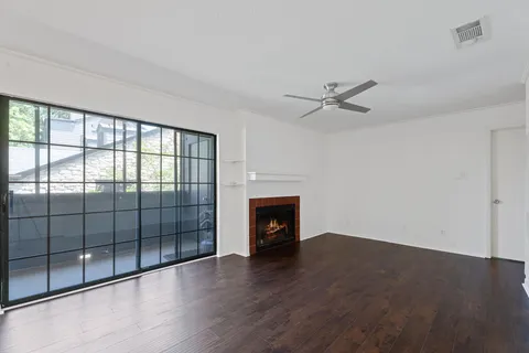 wooden floor in an empty room with a fireplace