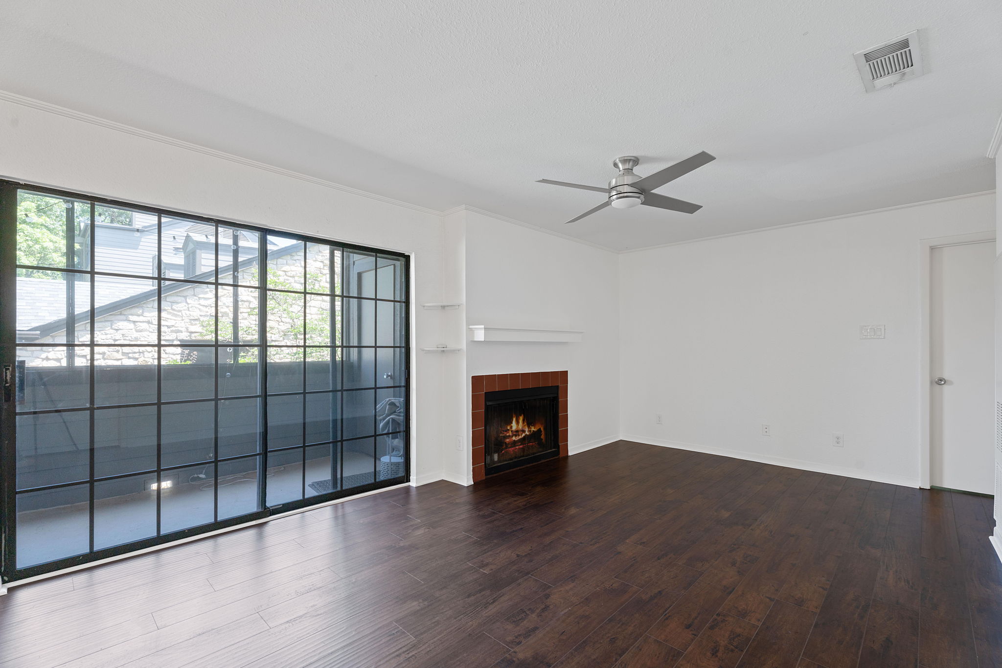1510 West N Loop Boulevard, Unit 424 Austin, TX 78756 - Photo 11 of 25 wooden floor in an empty room with a fireplace