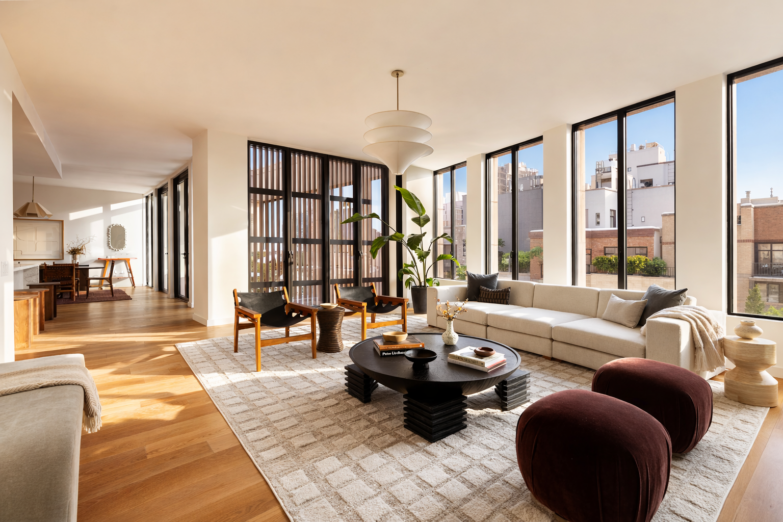 a living room with furniture and large windows