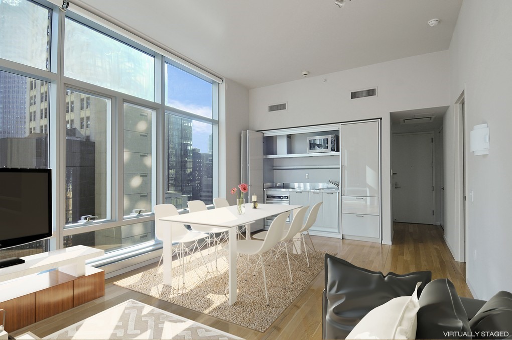 18 West 48th Street, Unit 23B Manhattan, NY 10036 - Photo 2 of 5 a dining room with furniture a chandelier and wooden floor