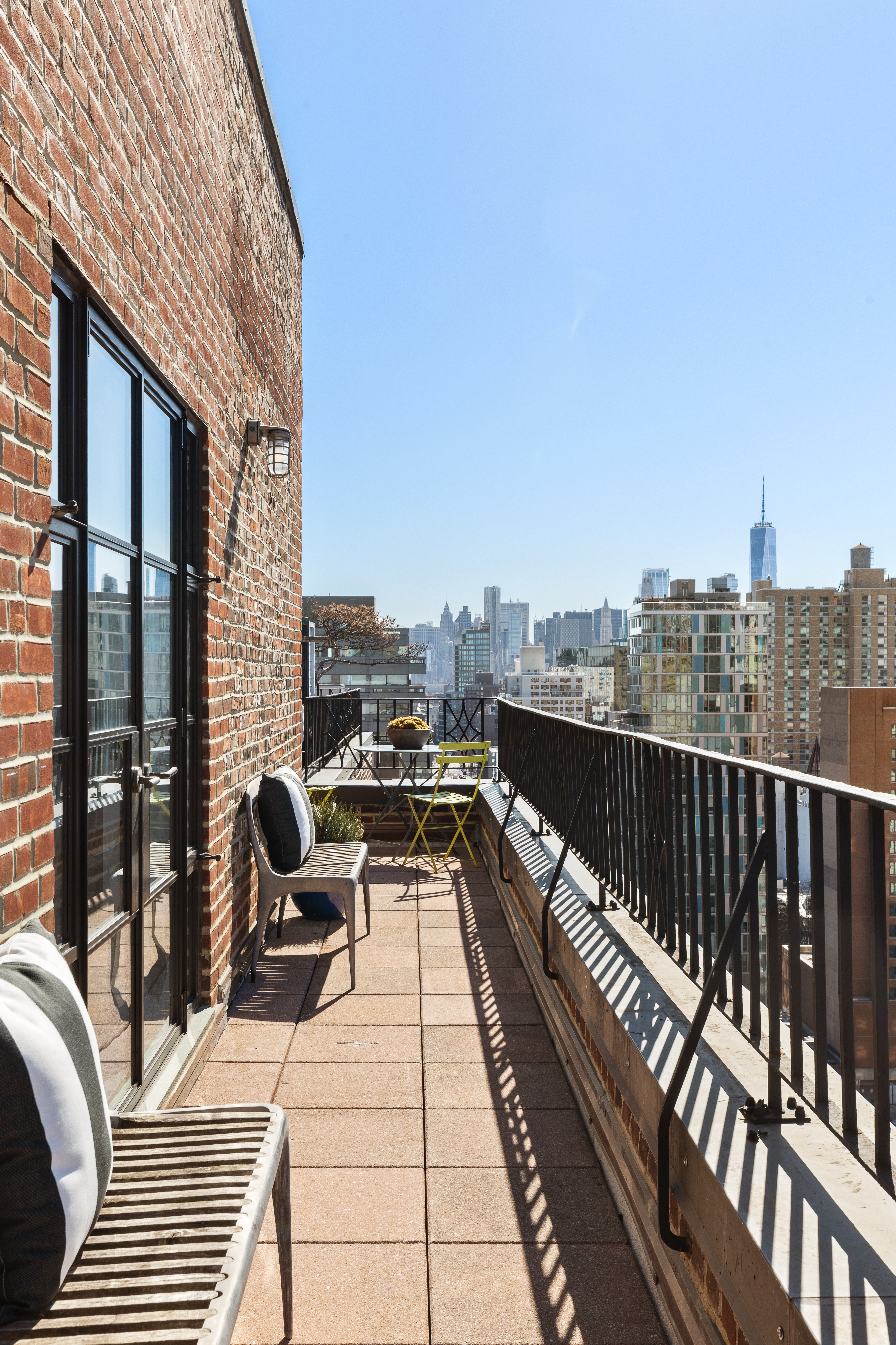 200 East 16th Street, Unit PHC Manhattan, NY 10003 - Photo 7 of 9 a view of balcony with couch and wooden floor