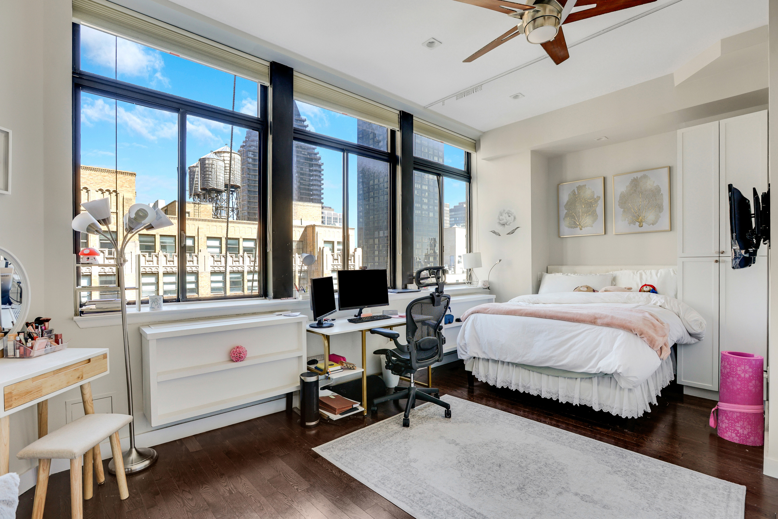 310 East 46th Street, Unit 16B Manhattan, NY 10017 - Photo 5 of 7 a bedroom with a bed and large windows
