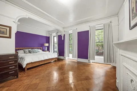 a spacious bedroom with a large bed and a fireplace