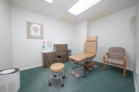 a living room with furniture and a chair
