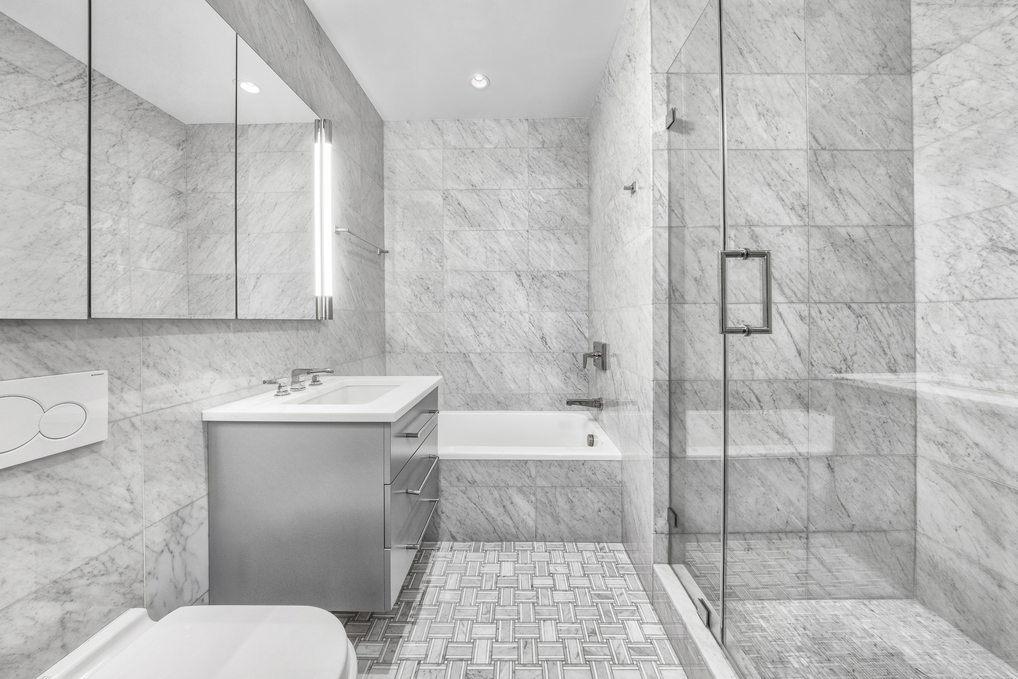 220 Madison Avenue, Unit 14/15O Manhattan, NY 10016 - Photo 14 of 18 a bathroom with a sink a toilet and shower