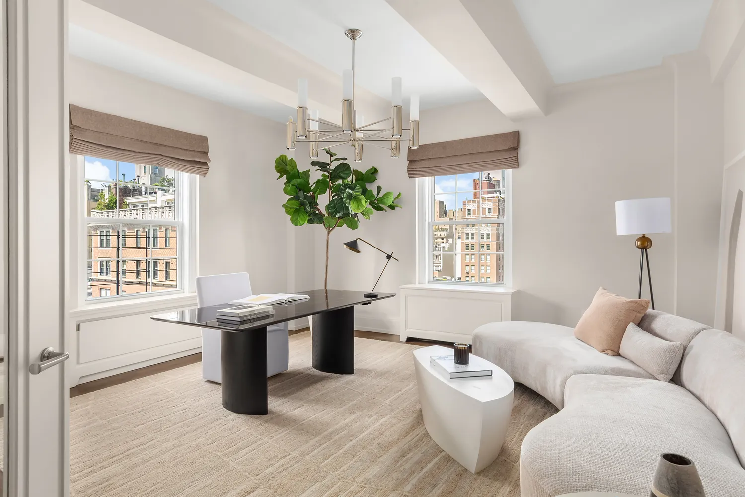 a living room with furniture a chandelier and a window