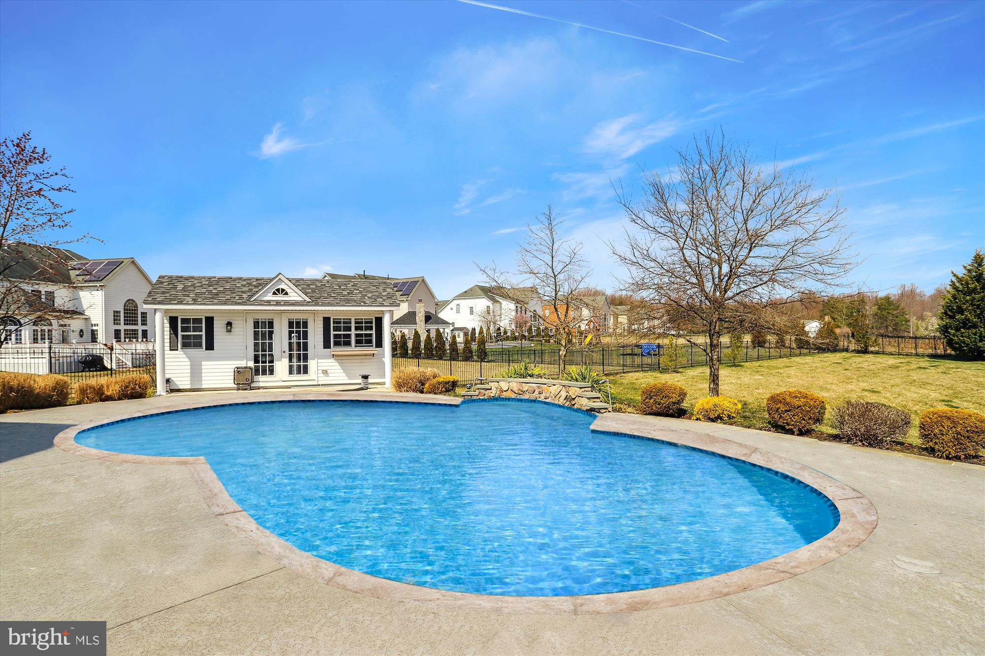 14302 Derby Ridge Road Bowie, MD 20721 - Photo 58 of 67 a view of a swimming pool with lawn chairs and plants