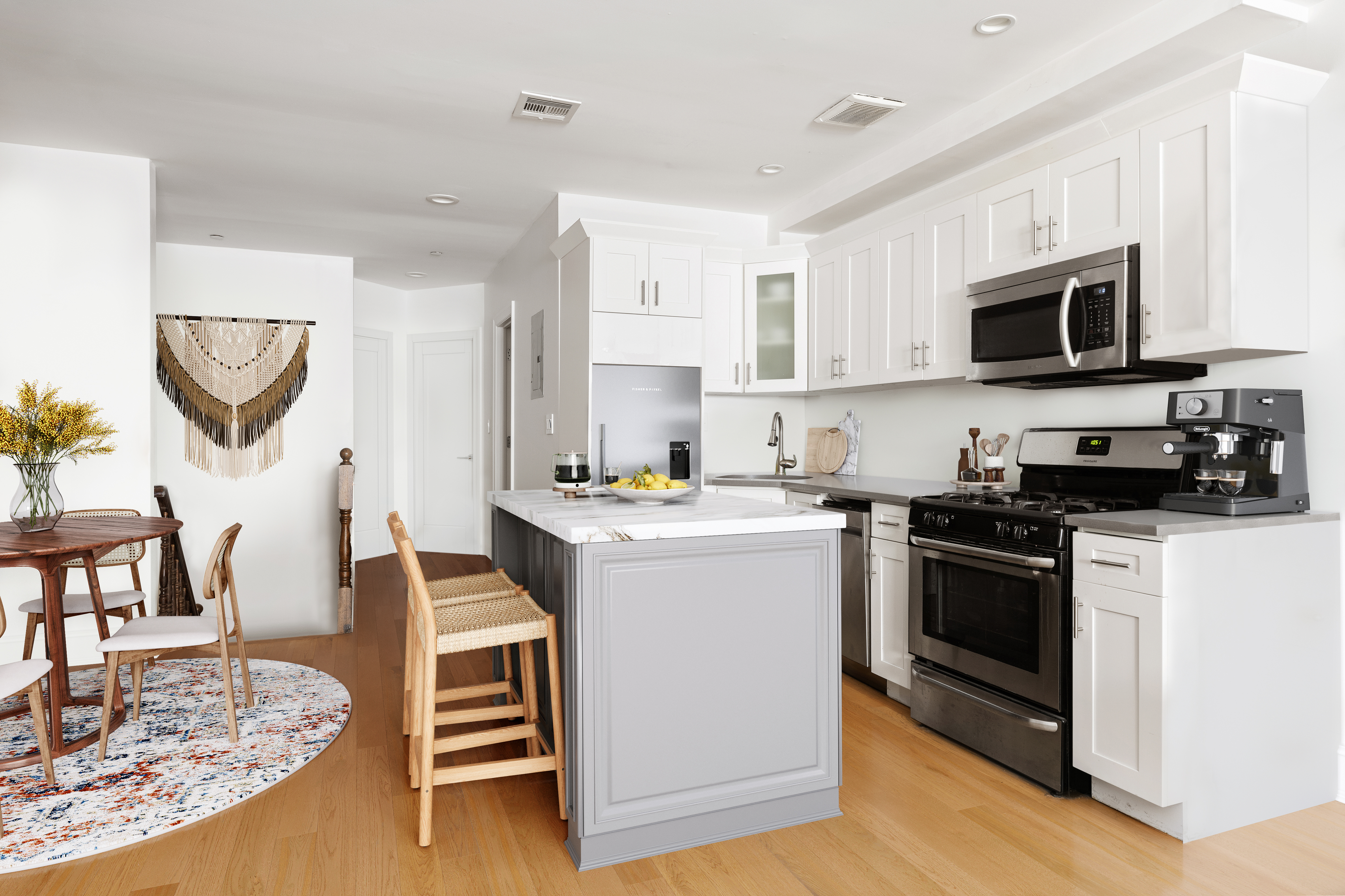 203 Halsey Street Brooklyn, NY 11216 - Photo 15 of 21 a kitchen with stainless steel appliances kitchen island granite countertop a stove top oven a sink a dining table and chairs with wooden floor