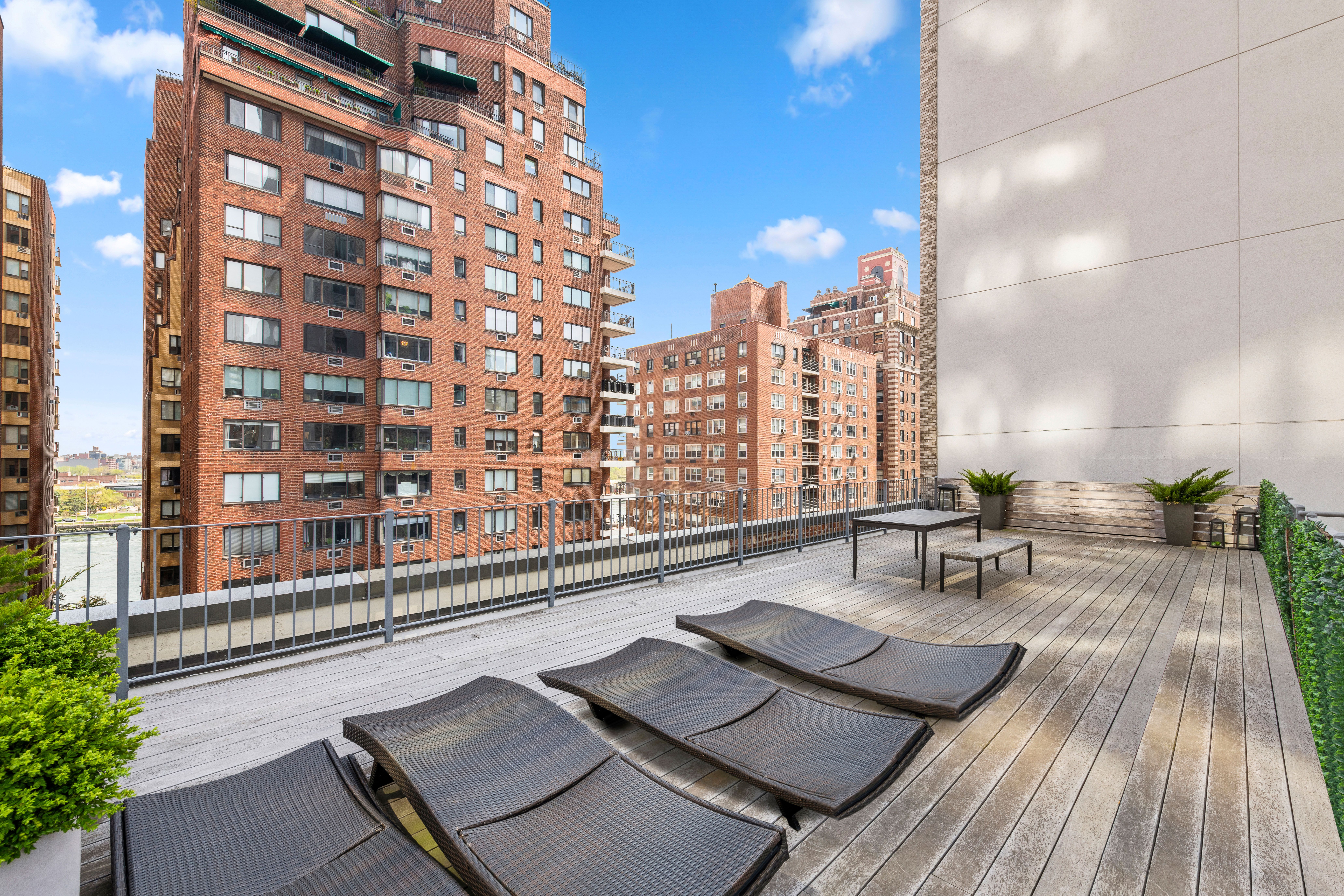 44 East End Avenue, Unit TH1 Manhattan, NY 10028 - Photo 11 of 14 a view of a balcony with chairs and wooden floor