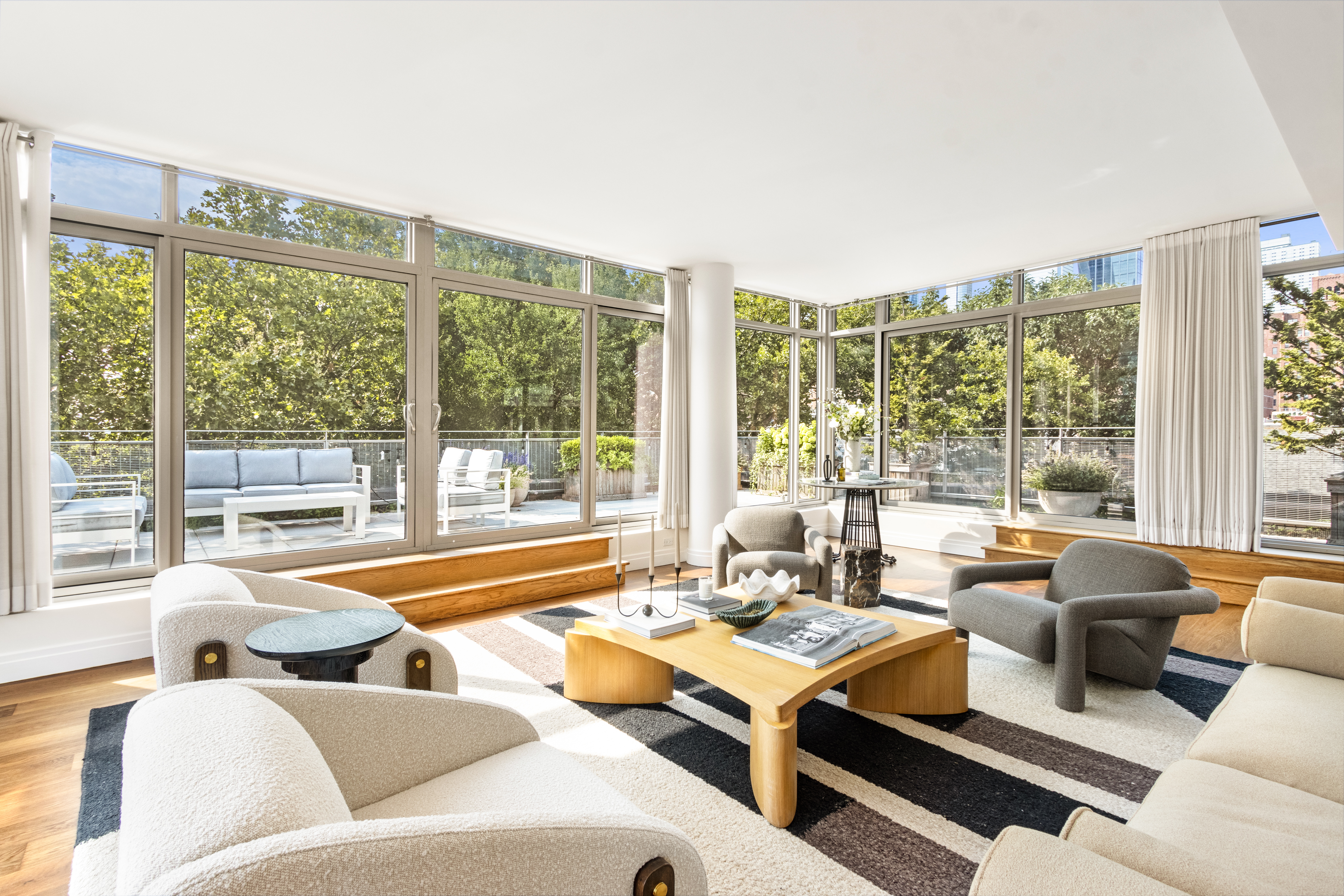 a living room with furniture and large windows