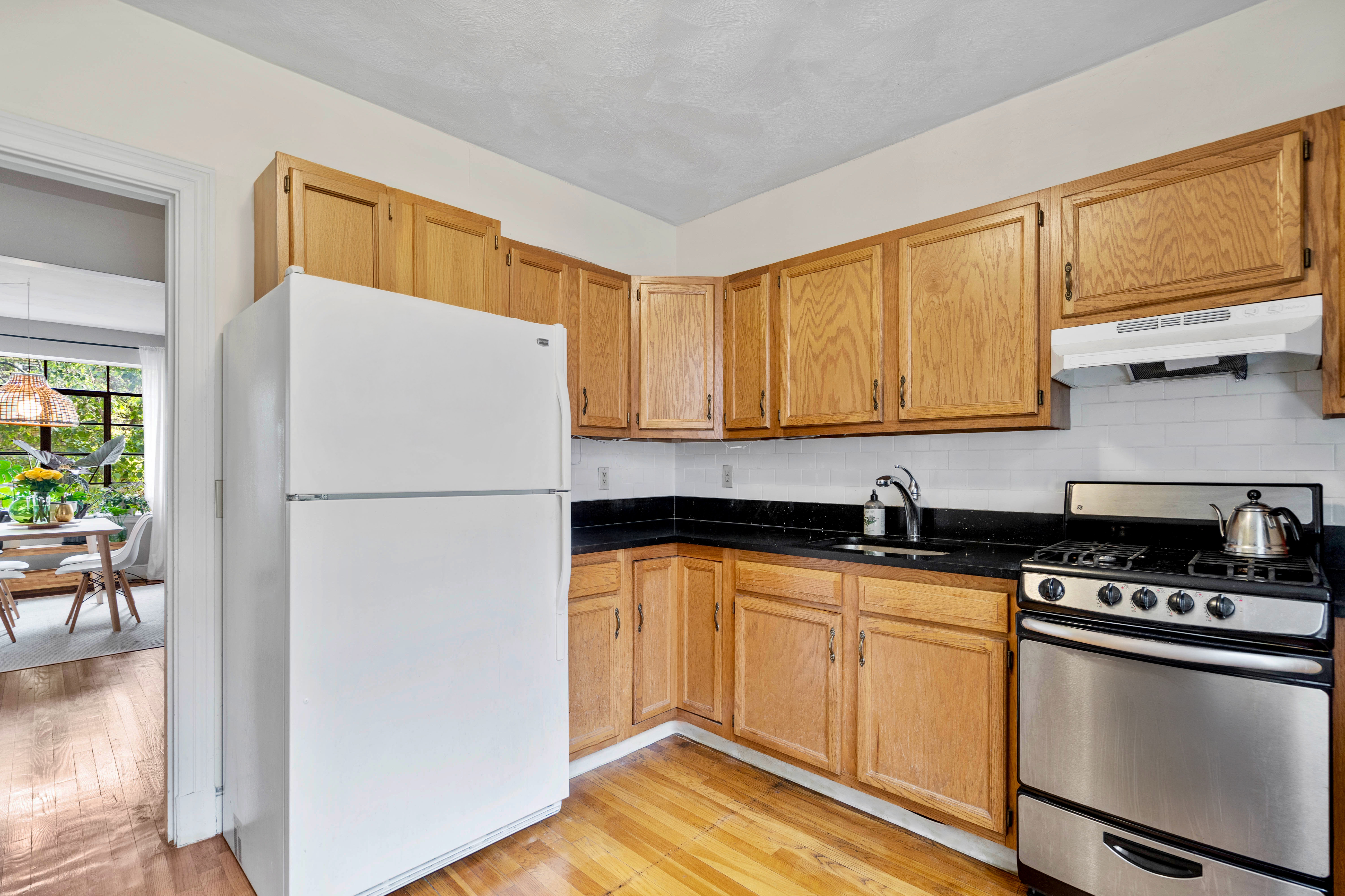 93 Strathmore Road, Unit 8 Brighton, MA 02135 - Photo 4 of 16 a white refrigerator freezer sitting inside of a kitchen