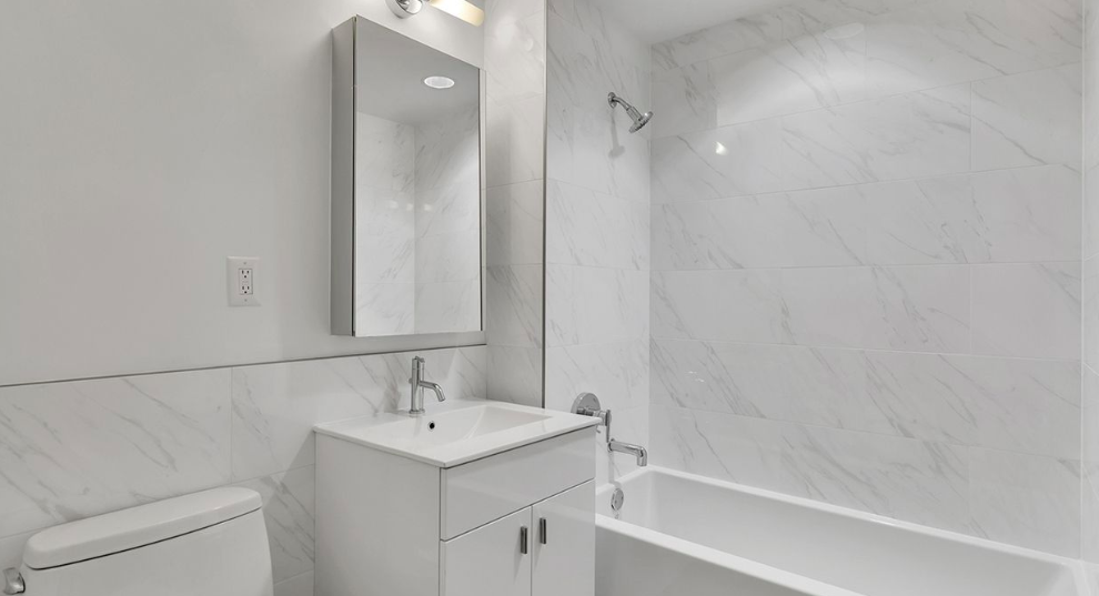 171 West 131st Street, Unit 519 Manhattan, NY 10027 - Photo 6 of 10 a bathroom with a sink and a bathtub