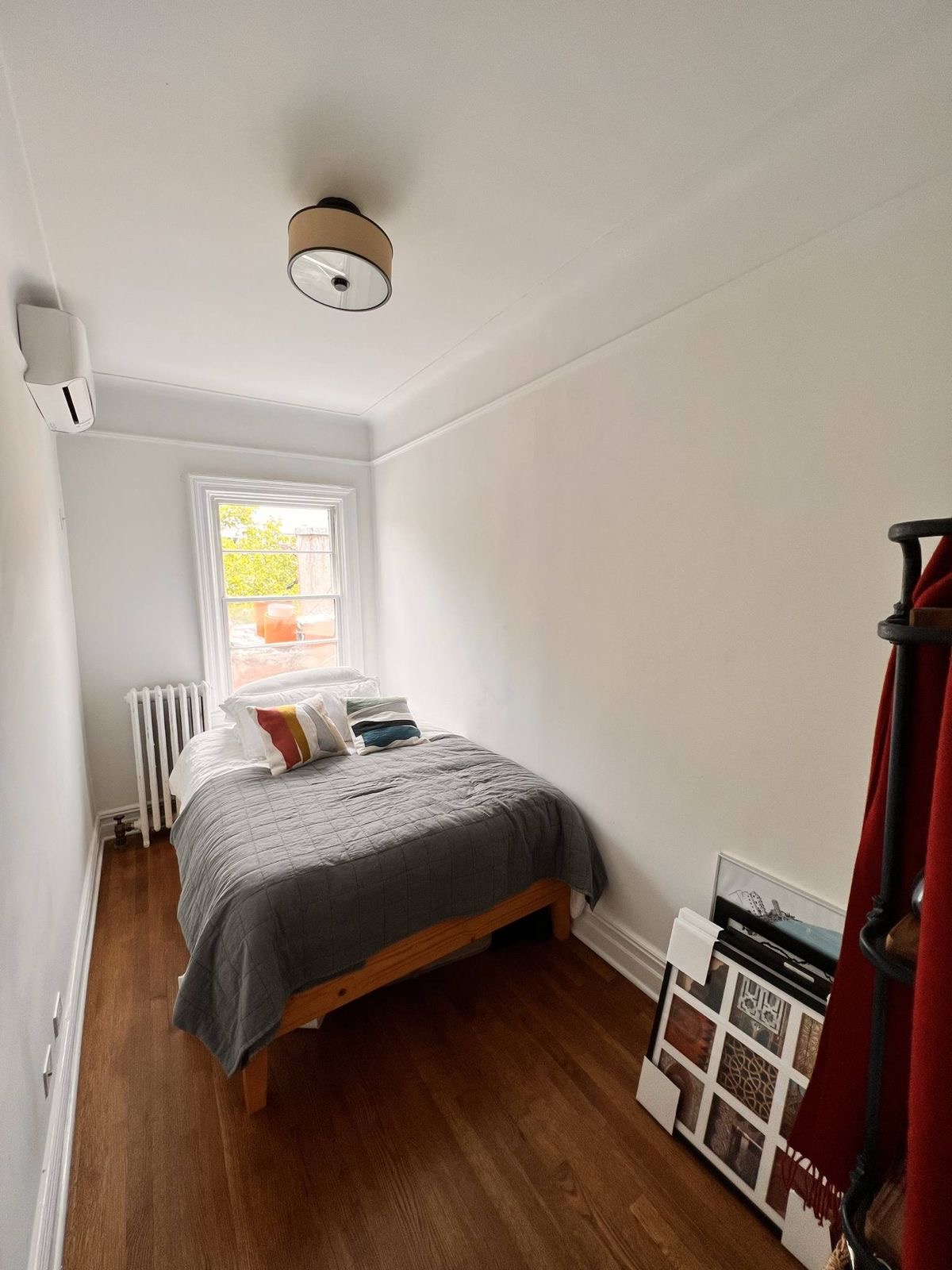 73 Perry Street, Unit 5 Manhattan, NY 10014 - Photo 8 of 10 a bedroom with a bed and a window