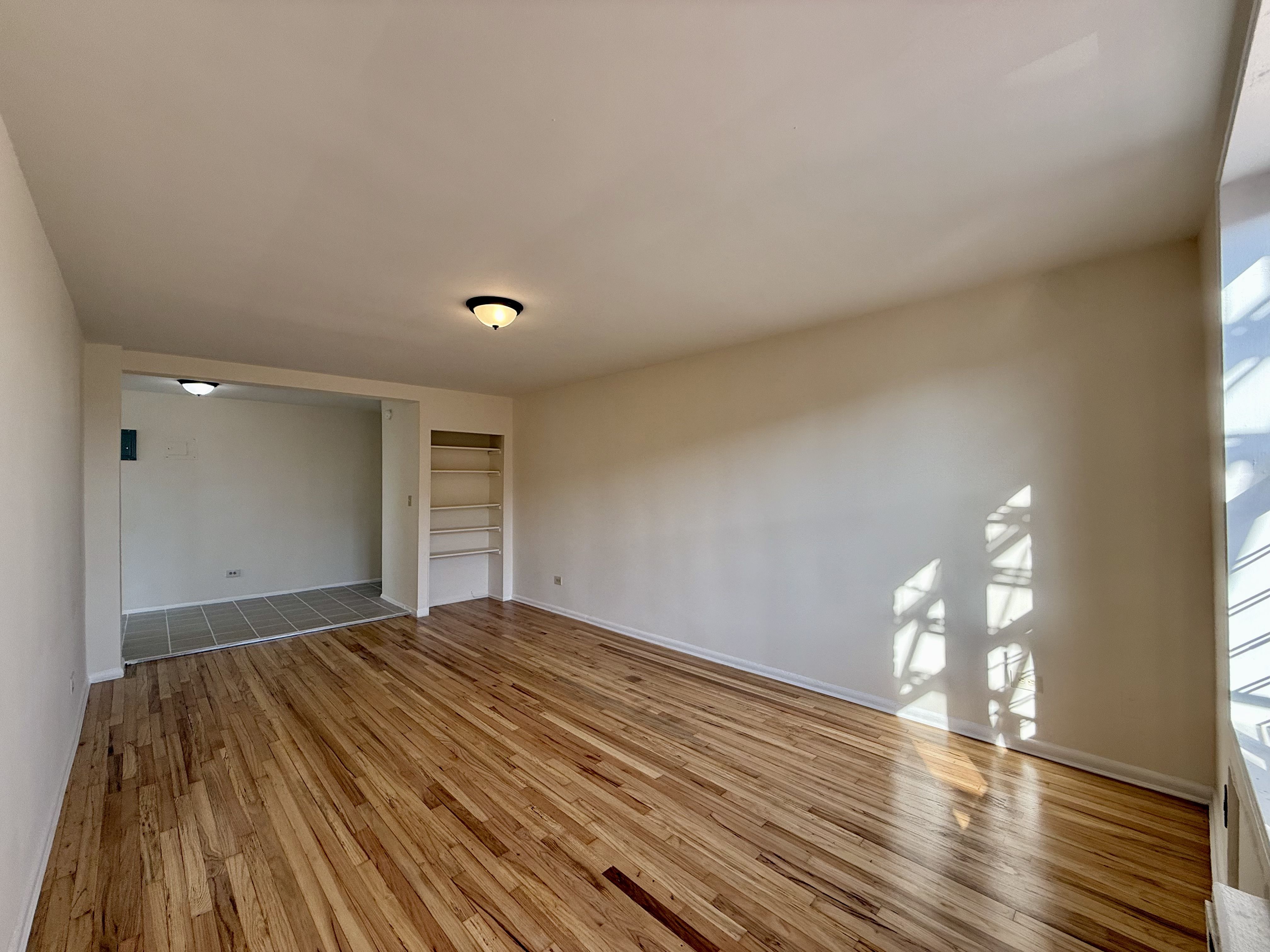 230 73rd Street, Unit 4B Brooklyn, NY 11209 - Photo 4 of 9 a view of empty room with wooden floor