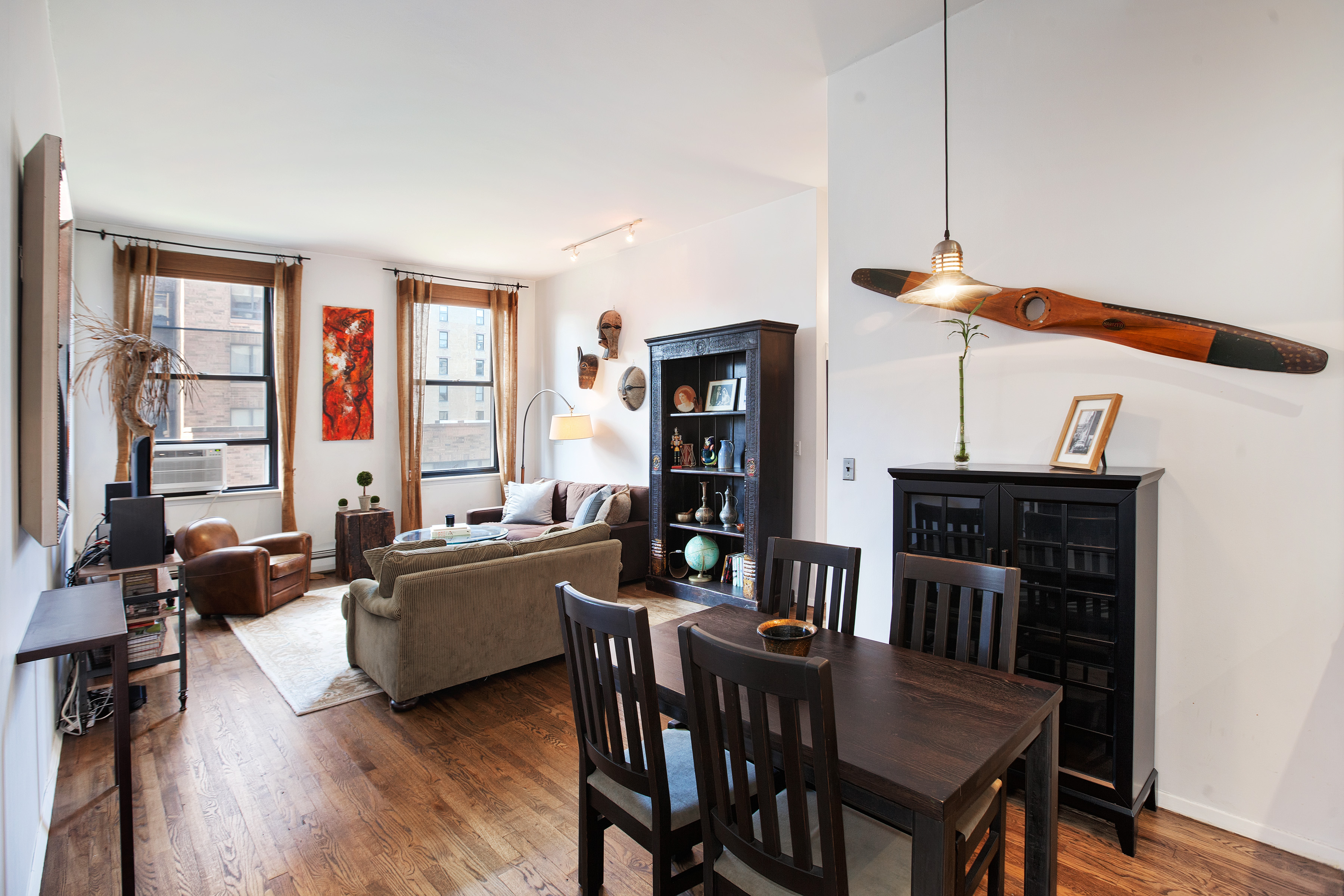 250 Mercer Street, Unit D603 Manhattan, NY 10012 - Photo 10 of 20 a living room with furniture and a flat screen tv