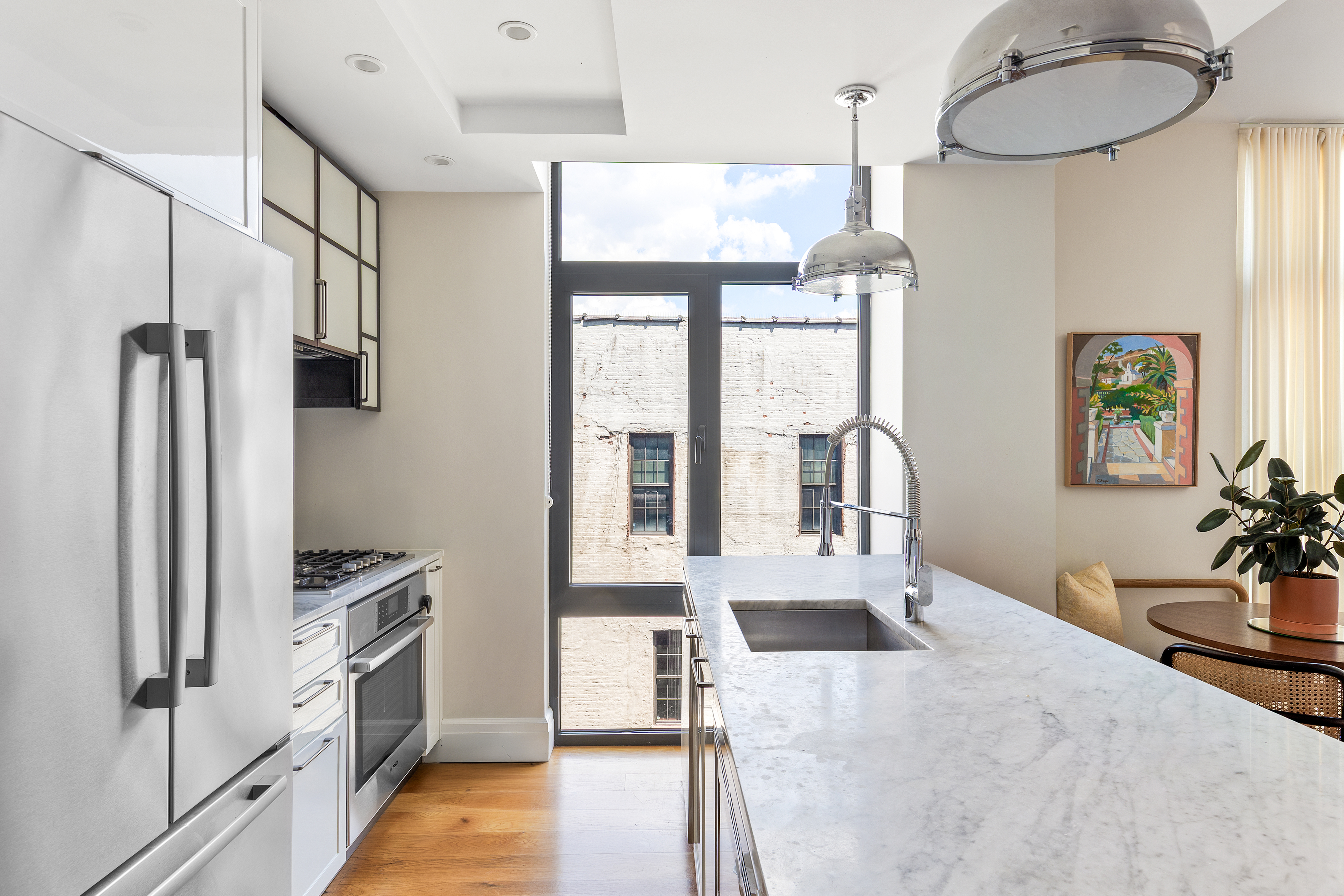 47 Bridge Street, Unit 5D Brooklyn, NY 11201 - Photo 5 of 21 a kitchen with stainless steel appliances kitchen island granite countertop a refrigerator and a sink