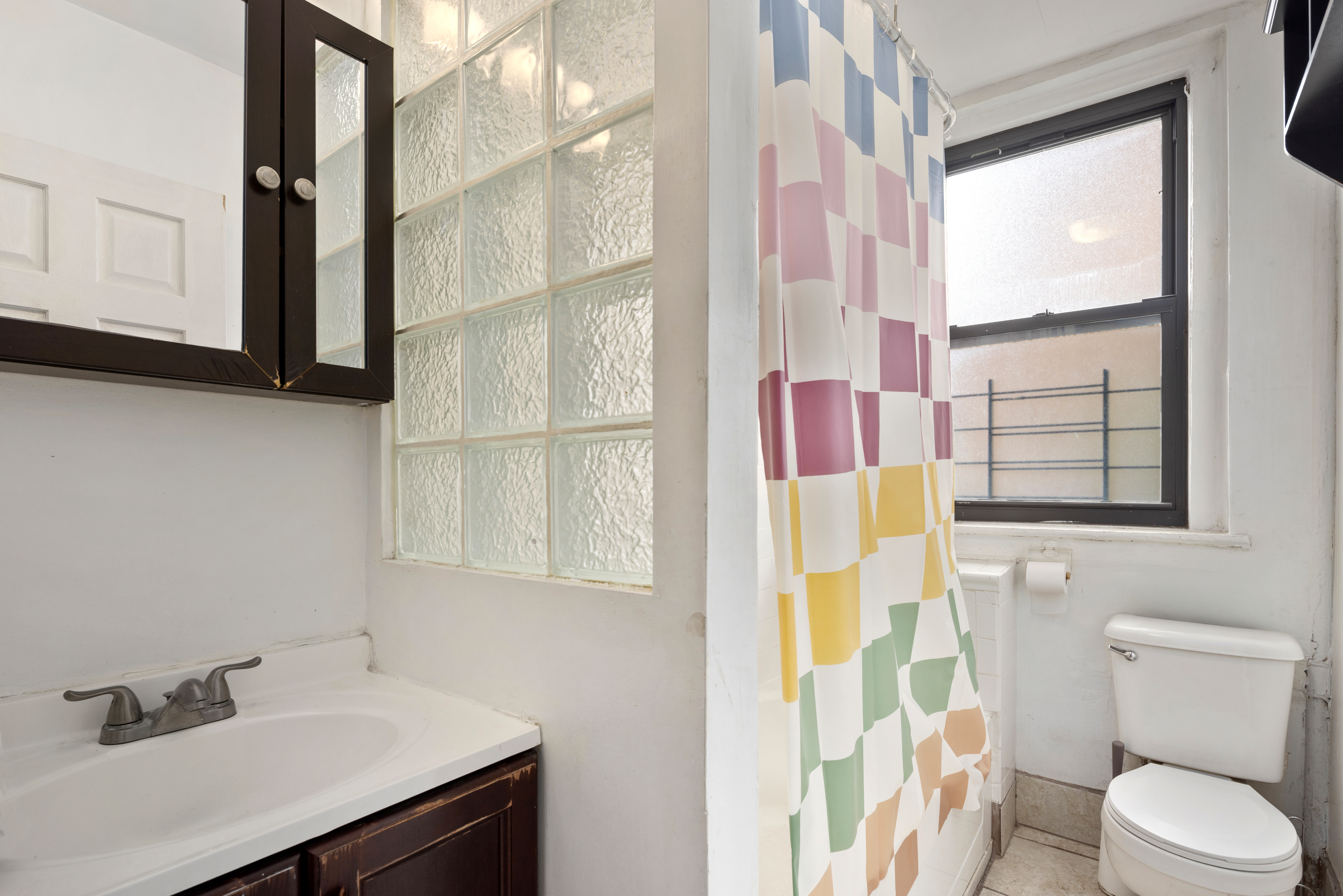 501 West 156th Street, Unit 44 Manhattan, NY 10032 - Photo 6 of 8 a bathroom with a sink toilet and shower