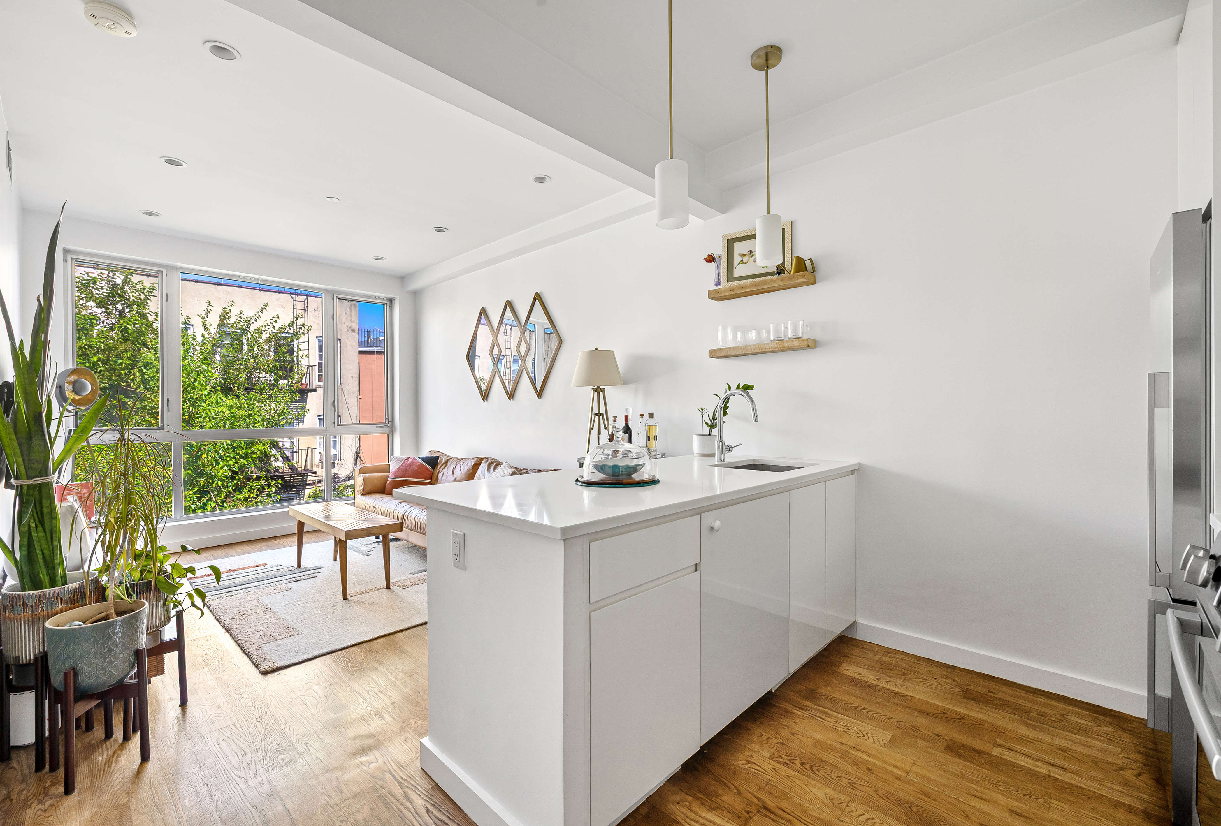 307 Cooper Street, Unit 3B Brooklyn, NY 11237 - Photo 3 of 10 a kitchen with a sink cabinets and window