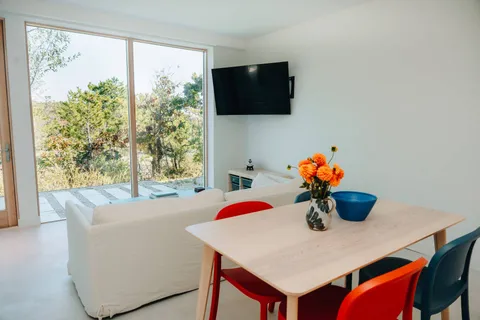 a view of a dining room with furniture and window