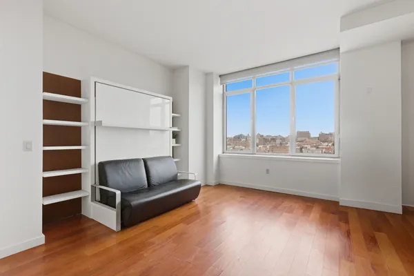 a living room with furniture and a floor to ceiling window