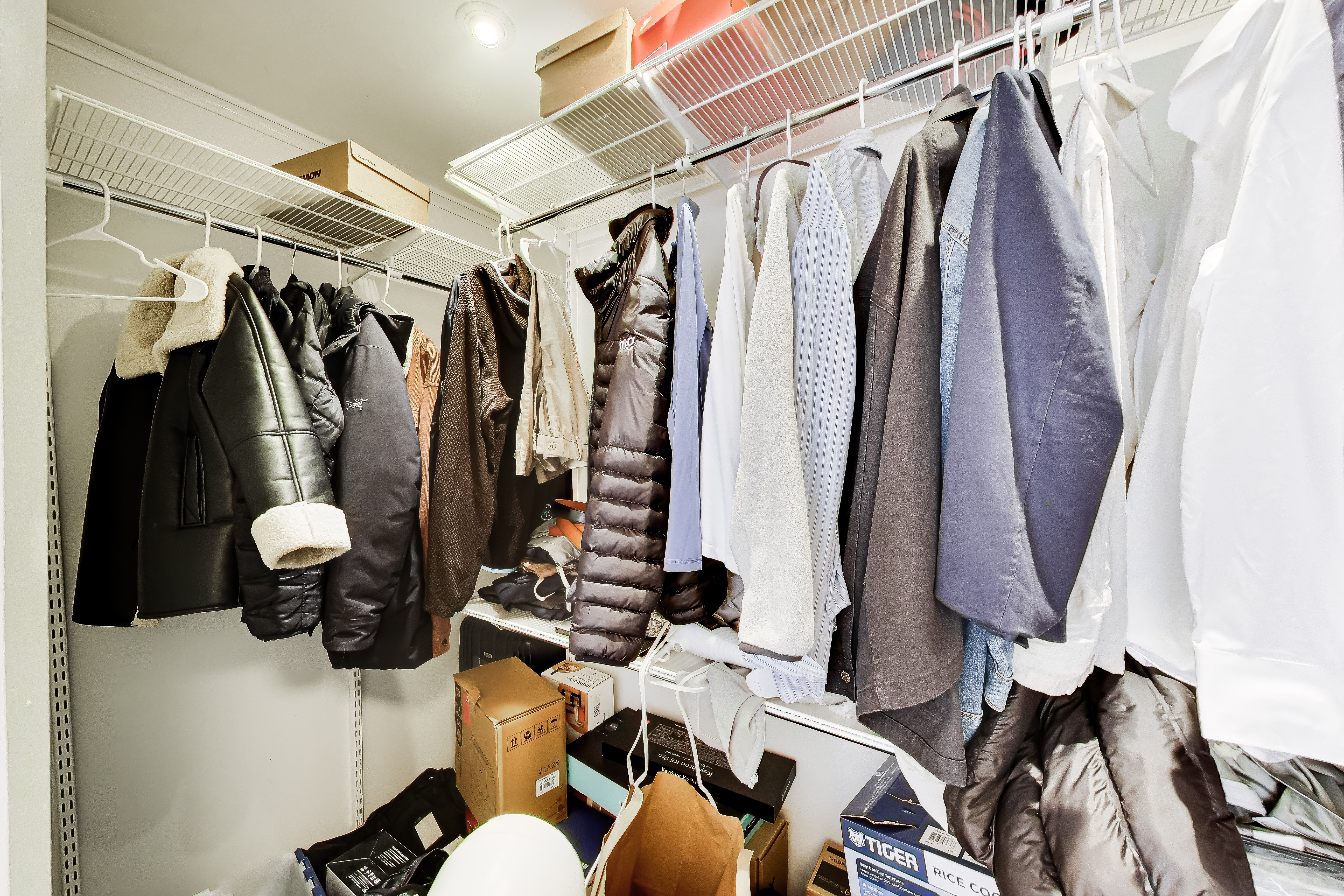110 East Delaware Place, Unit 1402 Chicago, IL 60611 - Photo 20 of 23 a view of walk in closet with clothes and shoes