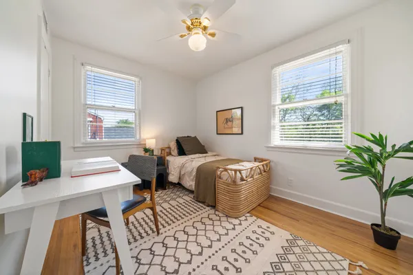 a bedroom with a bed and a potted plant