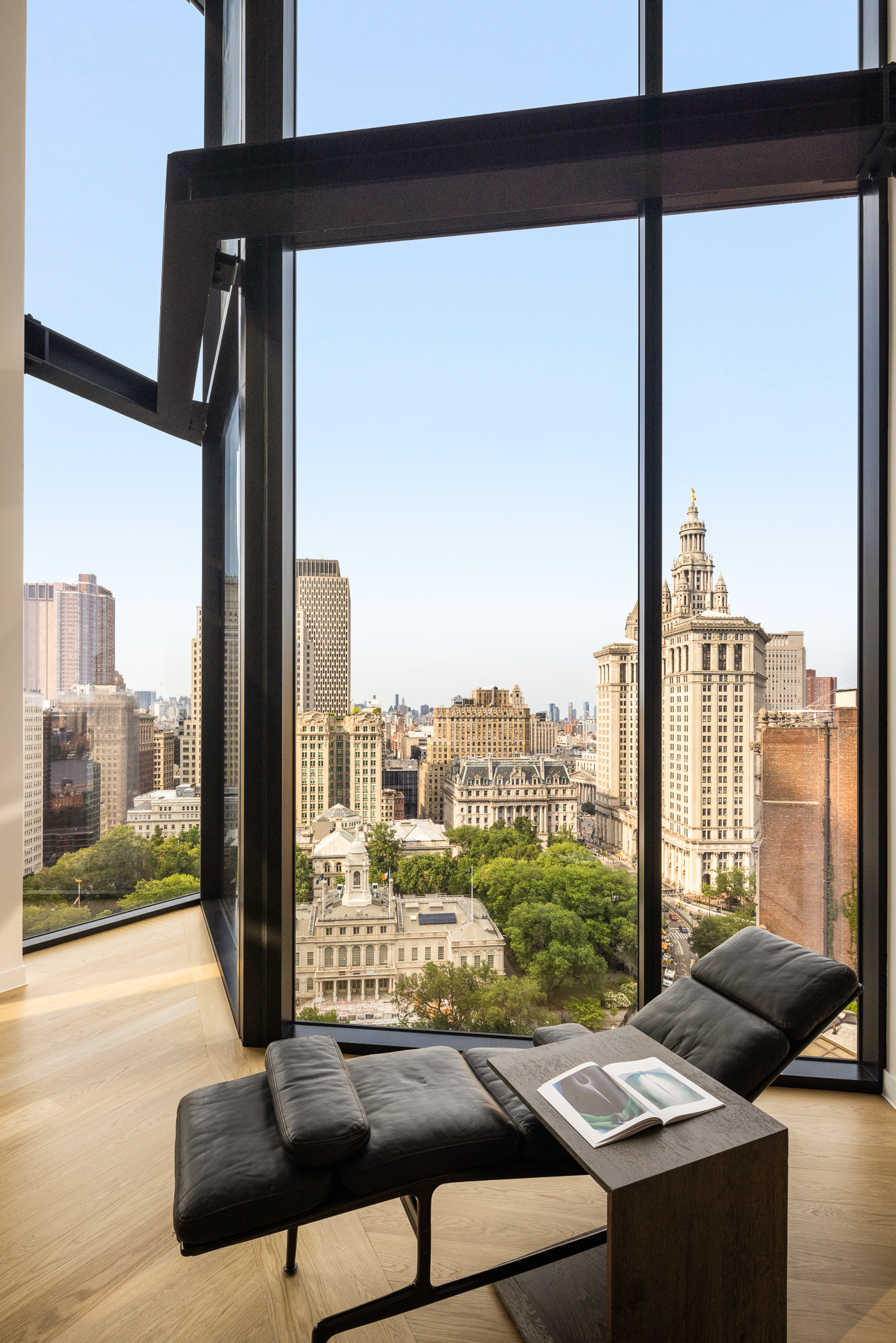 33 Park Row, Unit PH3 Manhattan, NY 10038 - Photo 5 of 30 a living room with patio furniture and a floor to ceiling window