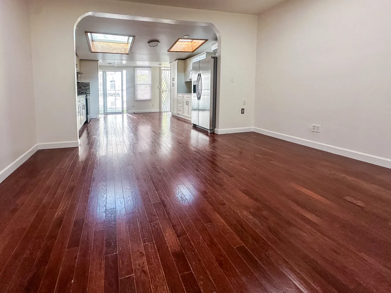 a view of a hallway with wooden floor