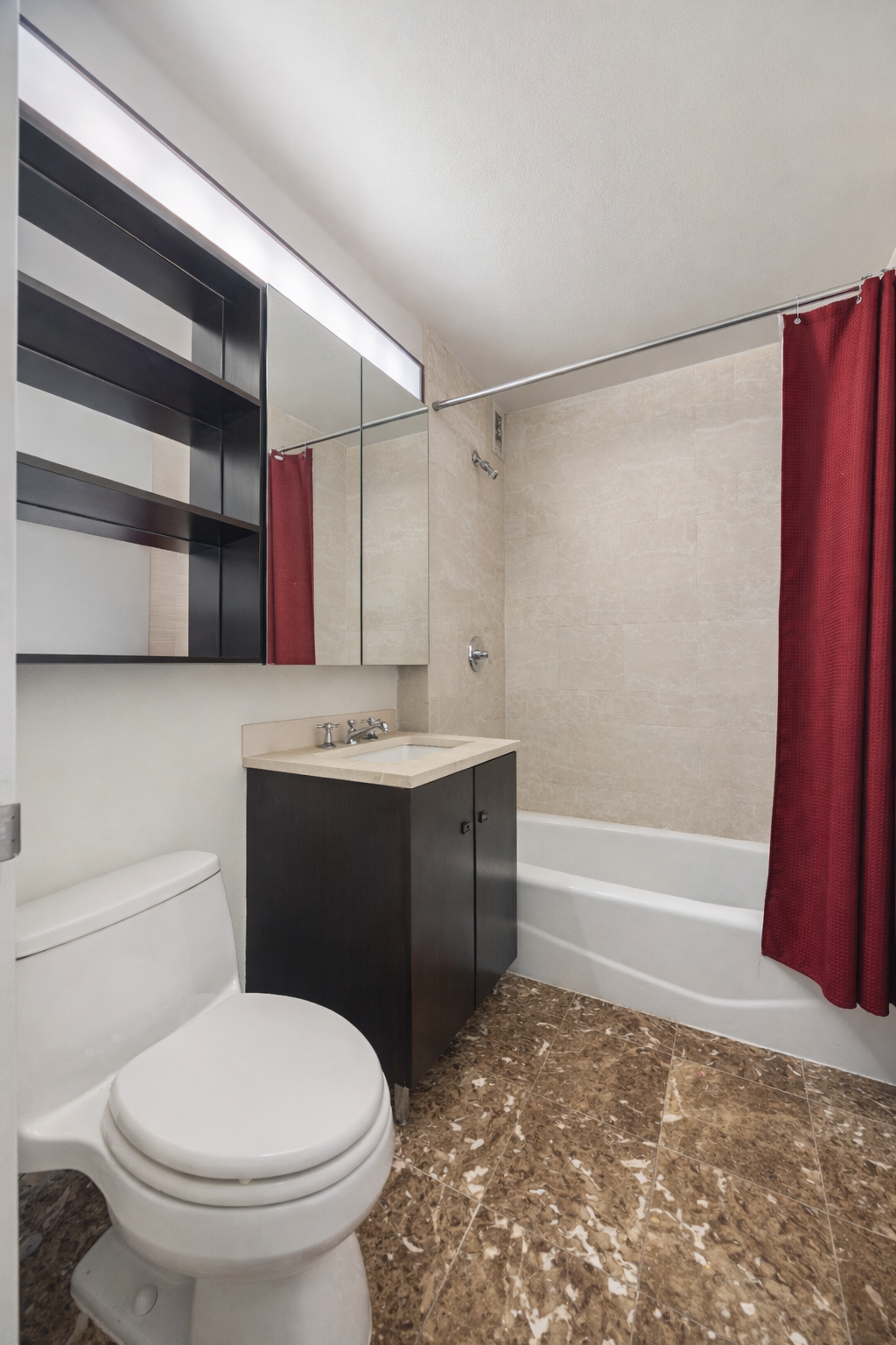 215-217 East 96th Street, Unit 26F Manhattan, NY 10128 - Photo 5 of 19 a bathroom with a sink toilet and shower
