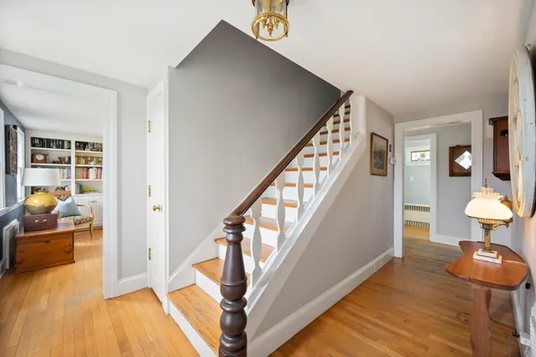 a view of entryway and hall with wooden floor