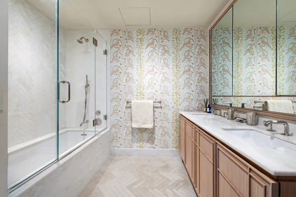 a bathroom with a granite countertop sink a toilet and shower
