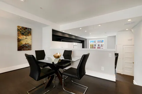 a view of a dining room with furniture and wooden floor