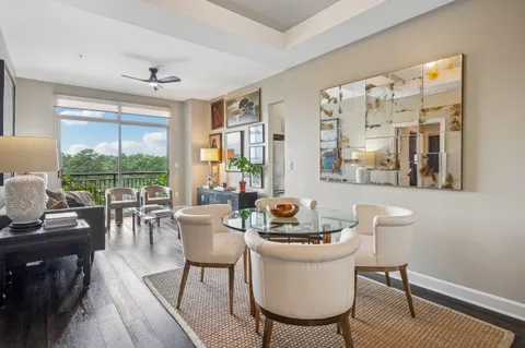 a dining room with furniture a rug and wooden floor