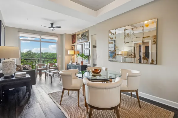a dining room with furniture a rug and wooden floor