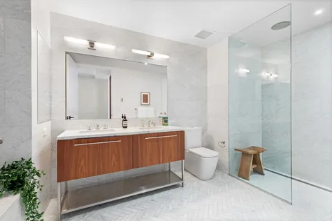 a spacious bathroom with a double vanity sink and a mirror