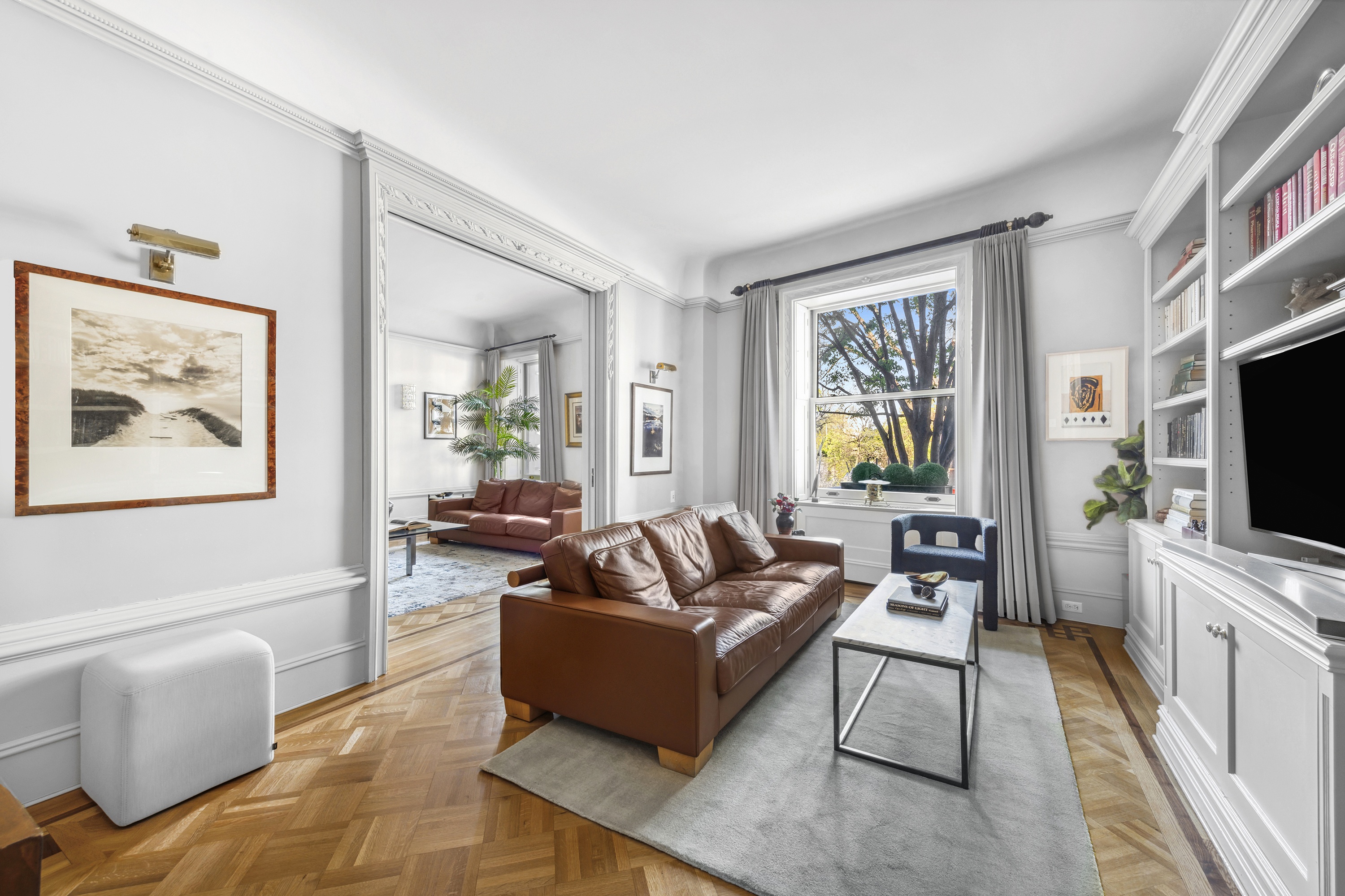 67 Riverside Drive, Unit 1A Manhattan, NY 10024 - Photo 3 of 18 a living room with furniture a flat screen tv and a window