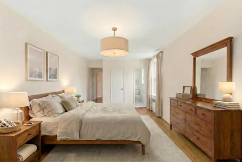 a bedroom with a bed and a dresser