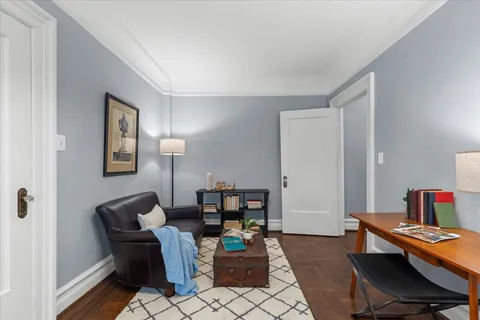 a view of a rooftop deck with lounge chairs and wooden floor